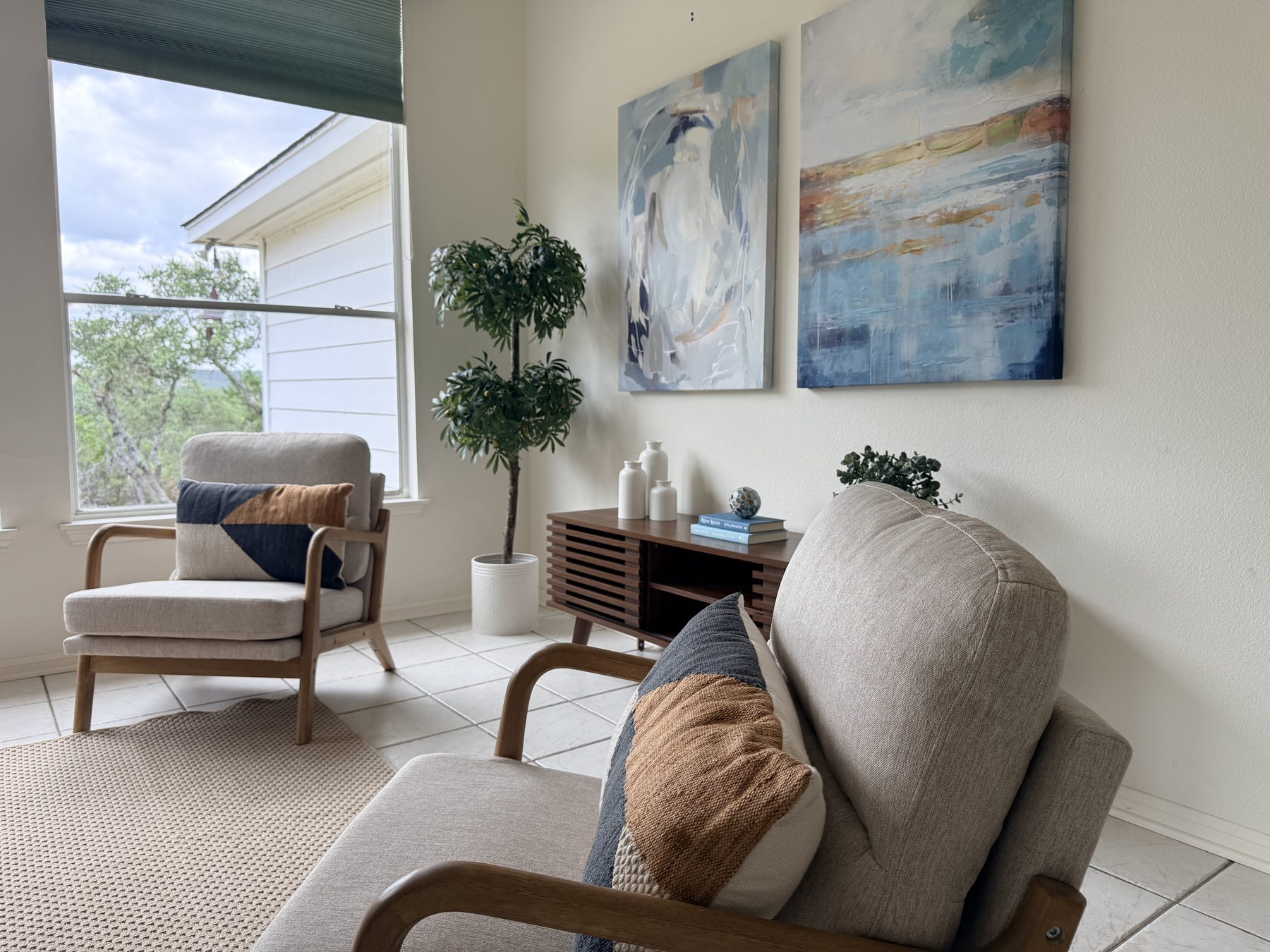 Highland Property Staging install — Sucha sitting area with accent chairs and credenza