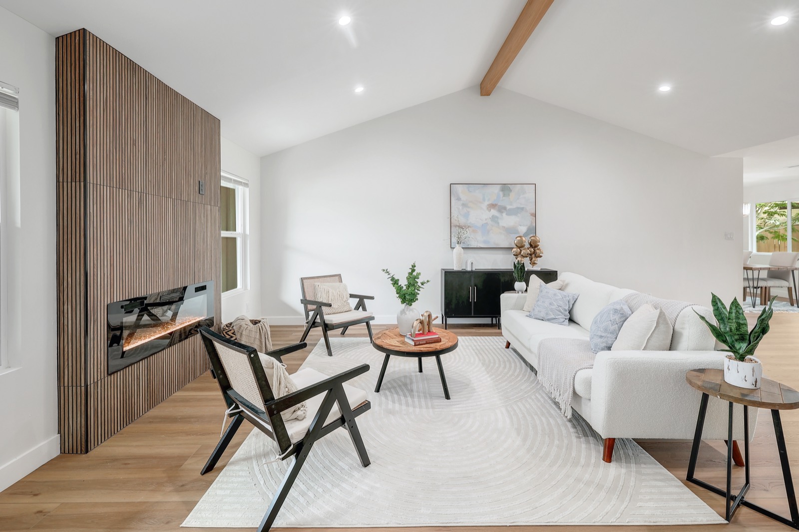 A Highland-staged living room with neutral palette and warm wood accents